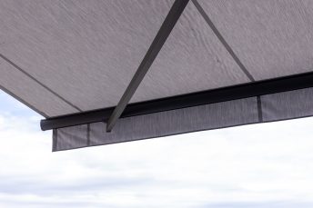 Weißgraue Doppelmarkise von schräg unten, anthrazitfarbenes Gestell, ausgefahrener Volant, installiert in Hotel Sennerbad Ravensburg.